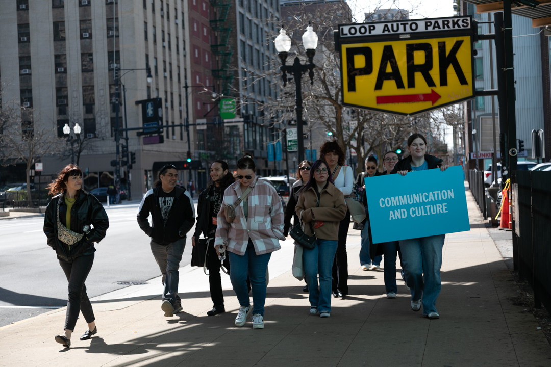 Parents and admitted students of the School of Communication and Culture walk under the L tracks for a campus tour on Saturday, April 11, 2026.