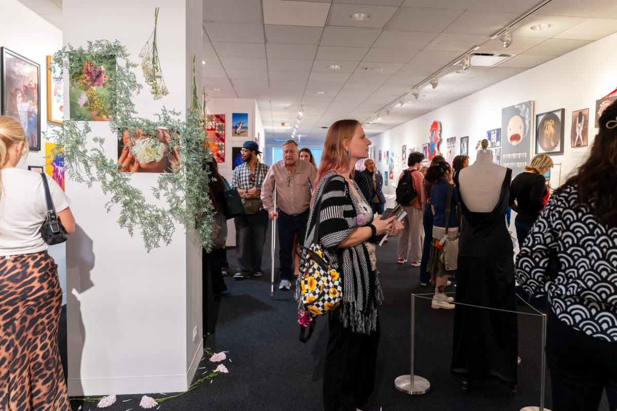 Guests look around the For Women, By Women exhibition at the Arcade Gallery in the 618 S. Michigan Ave. building on Friday, April 24, 2026.