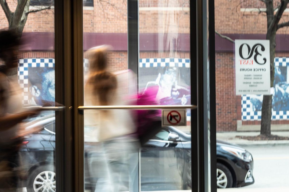 Students quickly enter and exit 30 East Balbo on Feb. 8, 2024. The college announced this week that housing demand has exceeded current available space for Fall 2026, but promises to provide additional spots for students waitlisted. (File)