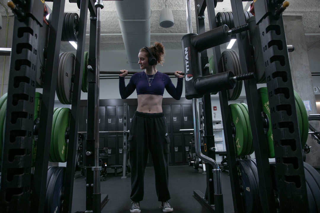 Callie Kubal, a senior film and television and photography double major, places weights on the rack at the Kinema Fitness Center on the 5th floor of the Student Center on Friday, April 10, 2026. 
