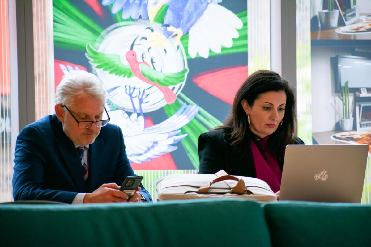 Chief of Staff Laurent Pernot and Lambrini Lukidis, associate vice president of Strategic Communications and External Relations, work at the Student Center during a Board of Trustees meeting on May 9, 2024. Both Pernot and Lukidis were laid off in 2026.