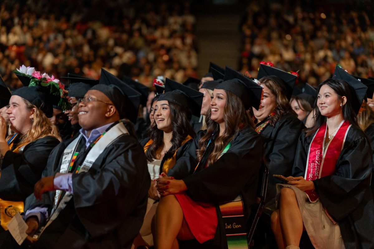 Graduates listen to speeches at the commencement ceremony at Credit Union 1 Arena on May 18, 2025.