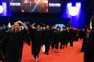 Faculty enter the afternoon commencement ceremony at Credit Union 1 Arena on Sunday, May 17, 2026. Columbia laid off six full-time tenured faculty members 10 days later as part of ongoing budget cuts tied to declining enrollment and a growing deficit.