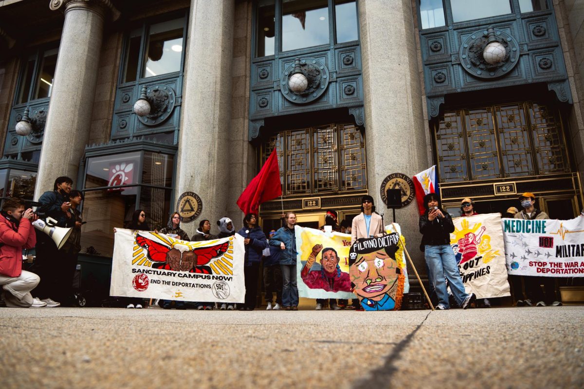 Protesters stand outside the Philippine Consulate General on Michigan Avenue on Friday, May 1, 2026.
