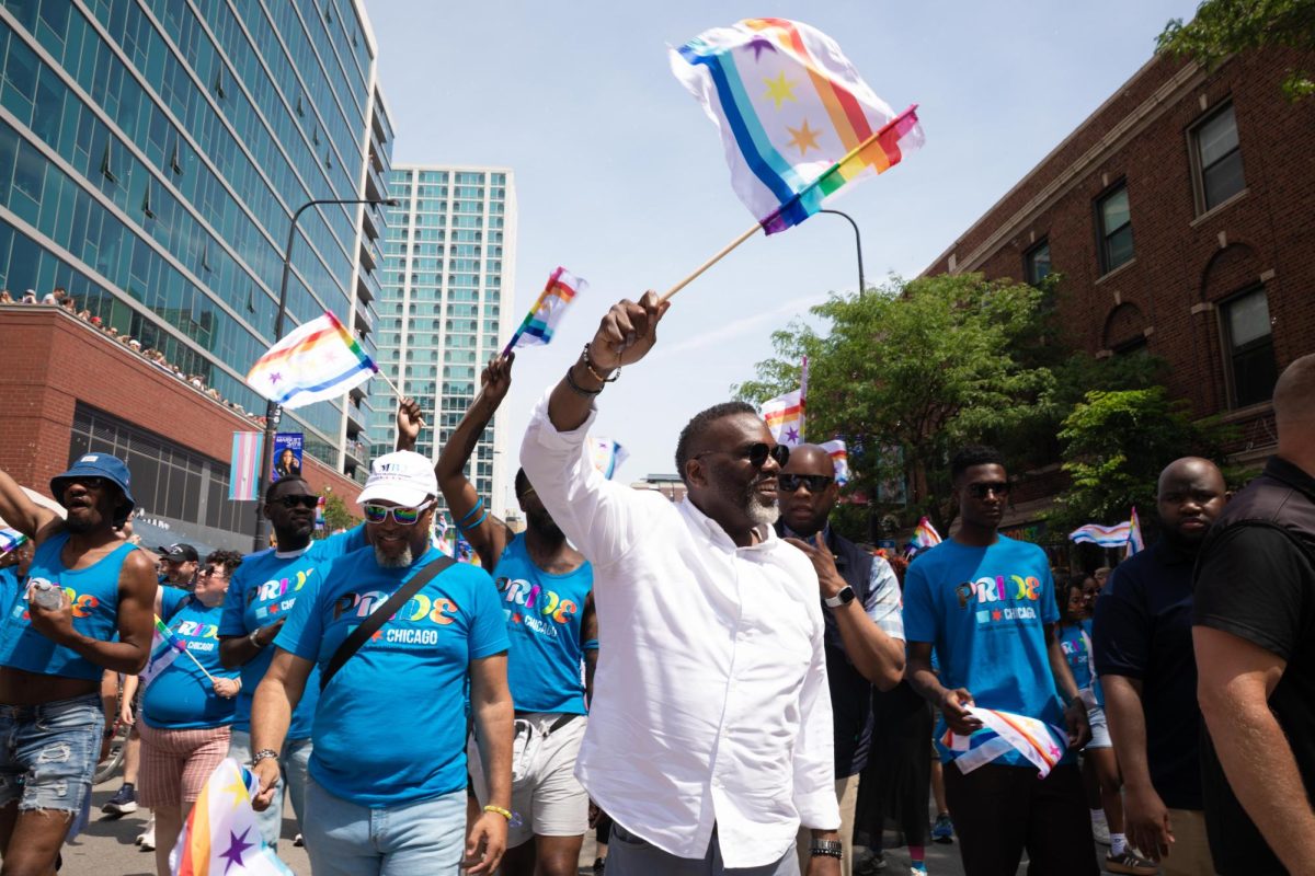 Chicago Mayor Brandon Johnson waves a rainbow Chicago flag during the 55th annual Chicago Pride Parade on Sunday, June 28, 2026.