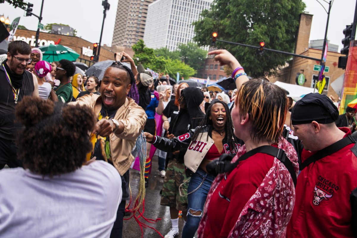 Attendees at Chicago Pride Fest sing and dance together on Sunday, June 21, 2026.