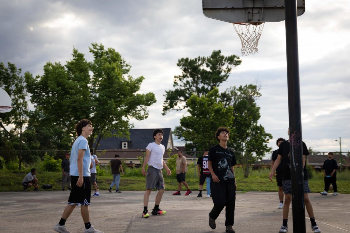 Young men look toward the basket during a pickup basketball game at Senka Park in the Gage Park neighborhood on the Southwest Side of Chicago on Wednesday, June 17, 2026. This photo is part of The Columbia Chronicle's "77 Community Areas" project documenting Chicago ahead of America's 250th birthday.