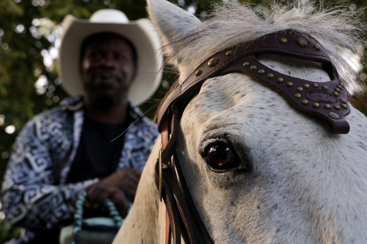 Eontell Annon talks to pedestrians while riding his horse through Stony Island on Chicago's South Side on Wednesday, June 24, 2026. This photo is part of the Columbia Chronicle's "77 Community Areas" project, documenting Chicago ahead of America's 250th birthday.