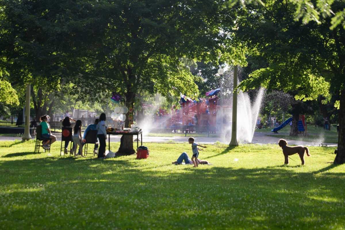 A group of people gather together at Marquette Park in the Chicago Lawn neighborhood on the Southwest Side of Chicago on Monday, June 13, 2026. Following intense storms and a severe weather outbreak that knocked out power across the South Side earlier in the week, cooler temperatures drew the residents back out to the neighborhood’s public parks. This photo is part of the Columbia Chronicle’s “77 Community Areas” project, documenting Chicago ahead of America’s 250th birthday.