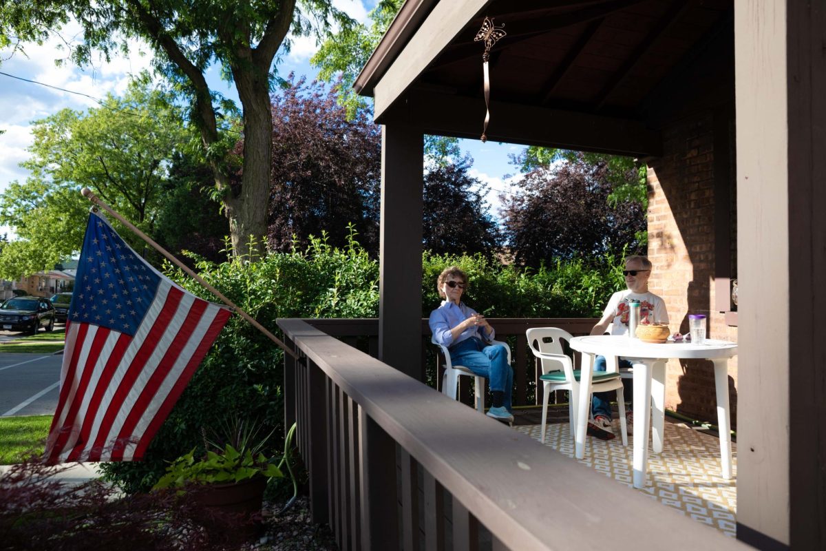 Daniel Derdzimski, a Columbia alum, sits on the front porch with his mother, Gloria Derdzimski, at her Garfield Ridge home in Chicago, where she has lived since 1956. This photo is part of the Columbia Chronicle’s “77 Community Areas” project documenting Chicago ahead of America’s 250th birthday.