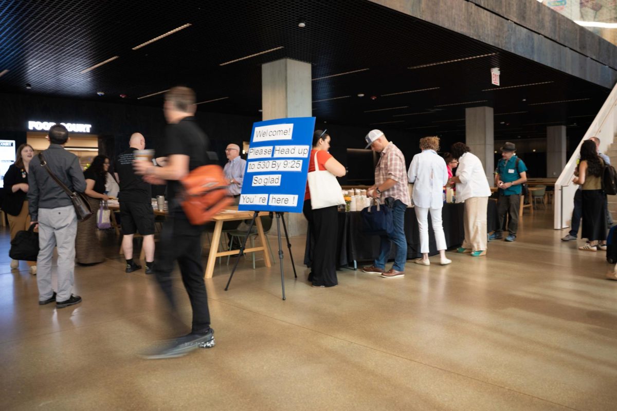 Staff and faculty linger on the first floor of the Student Center prior to the Fall 2026 summit on Tuesday, August 18, 2026.
