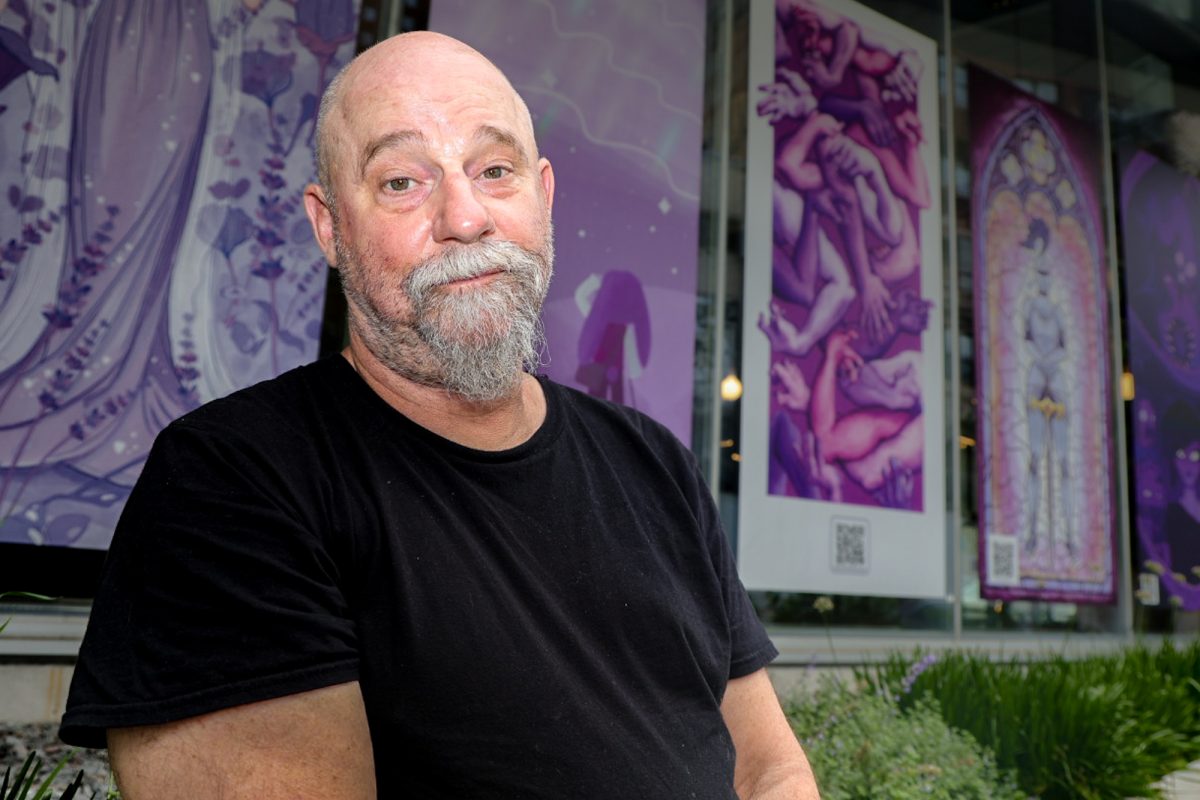 Joseph Lapsley, lead guitarist of PortmanteaZone and a history professor at Columbia College Chicago, poses for a portrait outside the Columbia College Student Center on Friday, July 31, 2026.