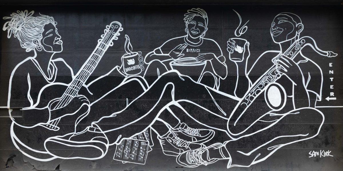 A line art mural painted by artist Sam Kirk features figures playing musical instruments and holding steaming mugs outside Bad Coffee on Friday, July 31, 2026.