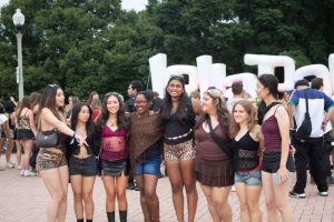 Lollapalooza attendees take a group photo next to the festival sign on Sunday, Aug. 2, 2026.