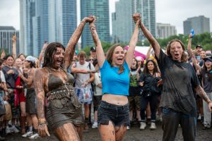 Lindsay Perrin, organizer of the impromptu event, declares the lesbians as winners of this round of Lesbian Mud Wrestling at Lollapalooza, Aug. 1, 2026.