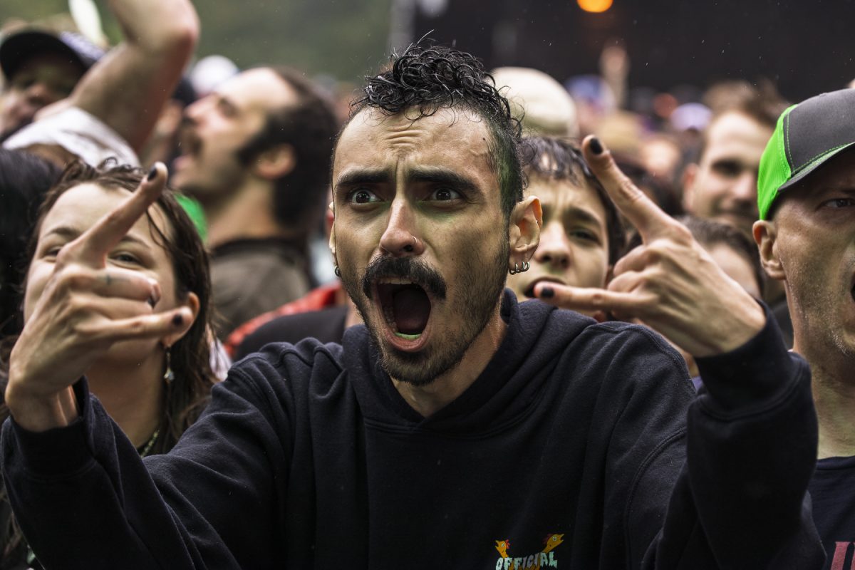 An attendee yells and holds up the devil horn hand gesture at the Radical Stage barricade during Haywire 617's set at Riot Fest on Sunday, Sept. 20, 2026.