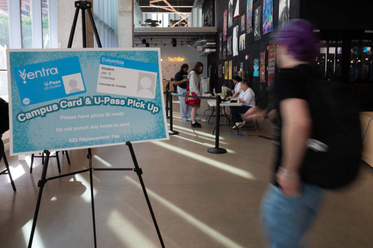 A sign directs students to the Campus Card & U-Pass pick up station inside the Student Center as students line up during the first week of classes on Tuesday, Sept. 8, 2026.