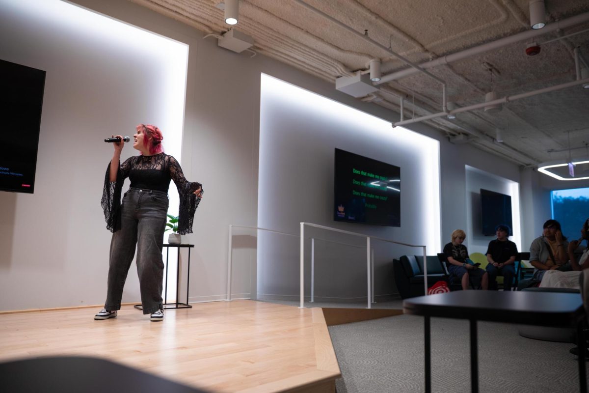 Naomi Espinoza performs "Crazy" by Gnarls Barkley during Karaoke Night at the HIVE inside the 618 S. Michigan Ave. building on Thursday, Sept. 10, 2026.