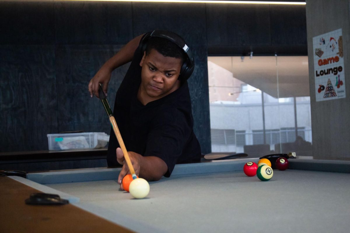 Kenneth Williams, a first-year film and television major, practices his pool skills on the fourth floor of the Student Center on Tuesday, Sept. 29, 2026