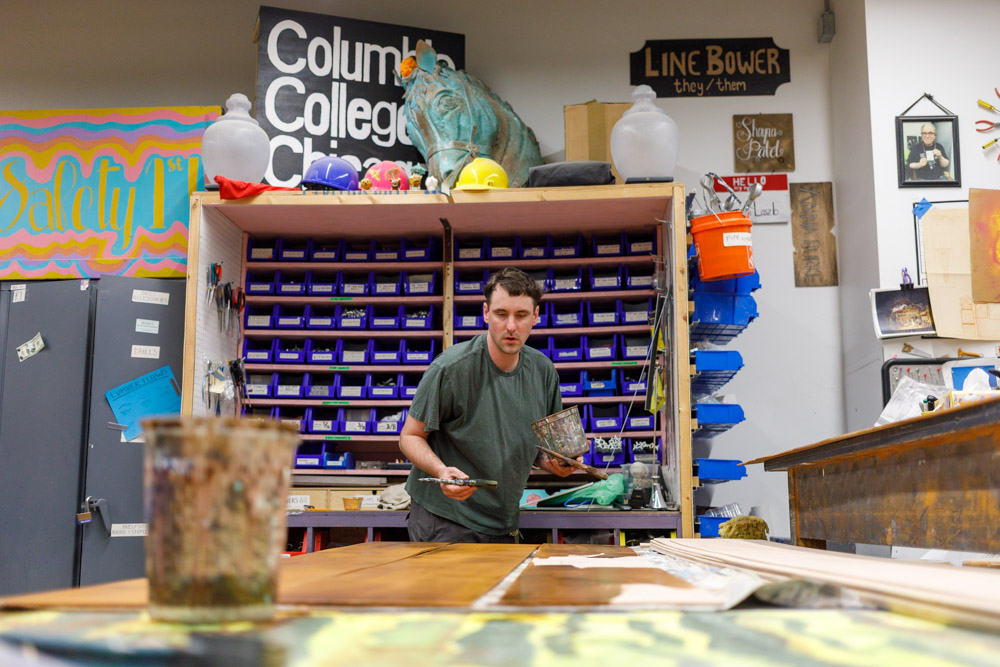 Kevin Rolfs, scene shop supervisor, stains wooden panels for the set of the upcoming theater production "The Color Purple" at the Theater Center on 71 E. 11th st. on Monday, Sept. 28, 2026.