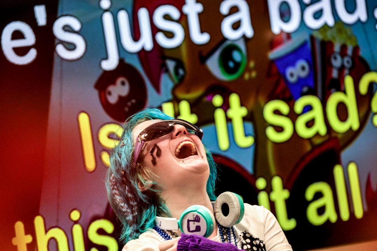 Nick Curry, a sophomore animation and computer graphics major, laughs on stage while singing “My Little Pony” during Costume Karaoke in the Hive, celebrating Wicked Week on campus on Tuesday, Oct. 27, 2026.