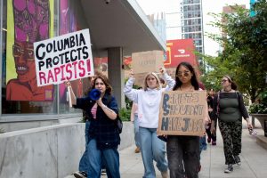 Students walk along South Wabash Avenue in protest of a residential assistant at the University Center accused of rape on Wednesday, Oct. 14, 2026.