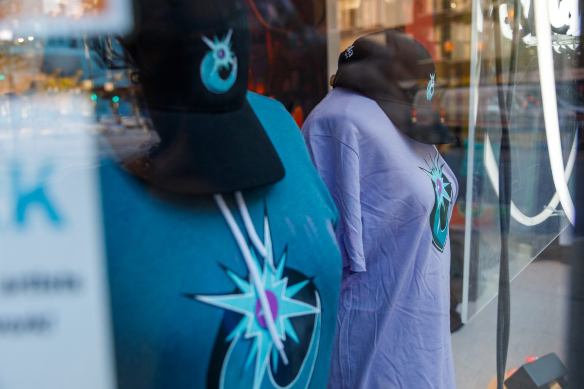 The new Cosmos merch including hats, t-shirts and long sleeved shirts, sit on display in the window of ShopColumbia on Wednesday, Oct. 28, 2026.