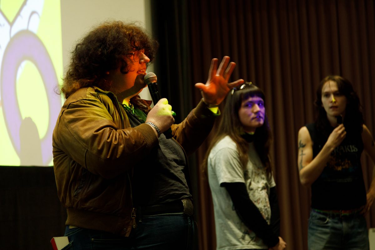 Gren Bee, writer and director of the movie “Trans Panic,” along with Laura Hammer, a film and television major, and Aurora Lowther, a theatre directing major, present the movie to a crowd Wednesday, Oct. 28, 2026, in the eighth-floor theater of the building at 1104 S. Wabash Ave.