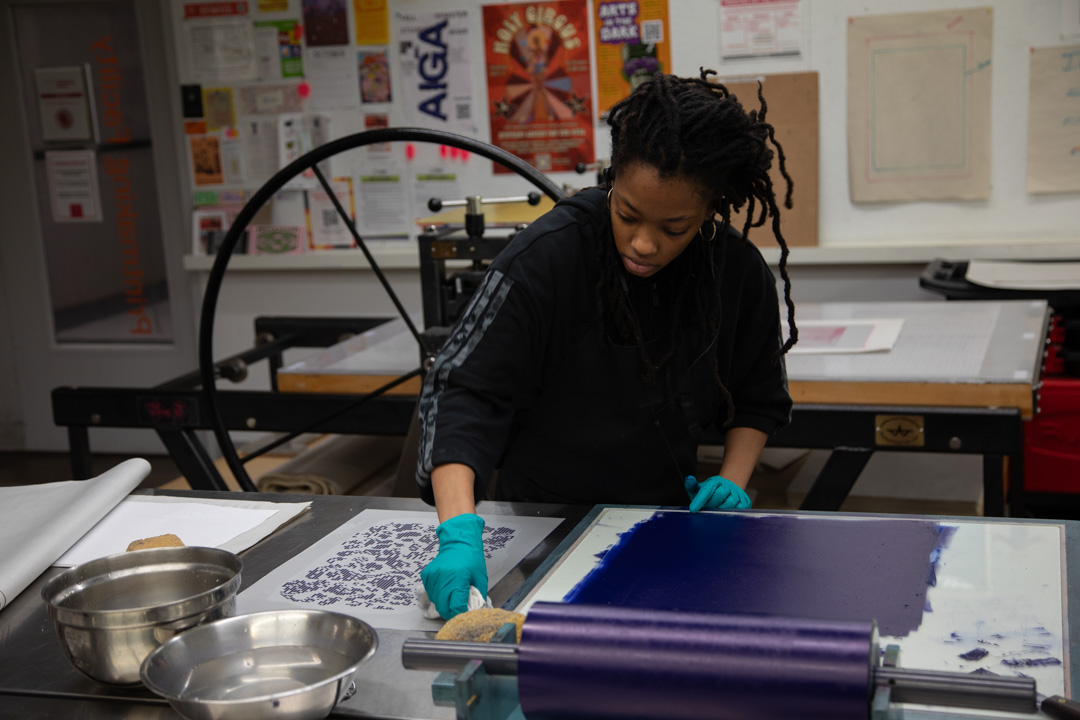 Talia White, a senior graphic design major, works on a print in the printmaking studio on the second floor of the 623 S. Wabash Ave. building on Friday, Oct. 9, 2026.