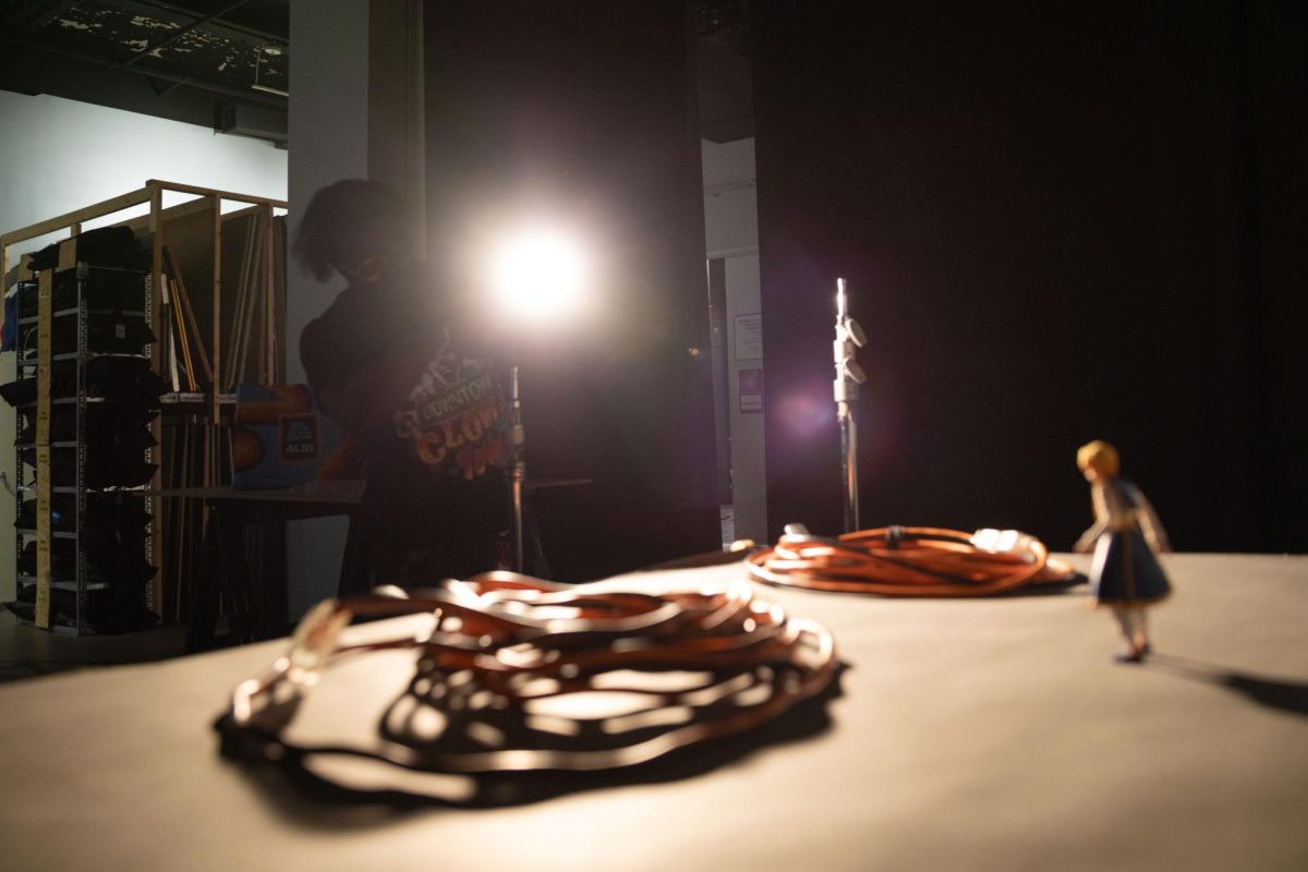 Christopher Bonds, a sophomore photography major, sets up lighting inside the second-floor studio at the 1104 S. Wabash Ave. building during an Advanced Studio Practice class on Monday, Oct. 26, 2026. Bonds prepared the studio space and lighting arrangement to shoot still-life photographs featuring action figures.