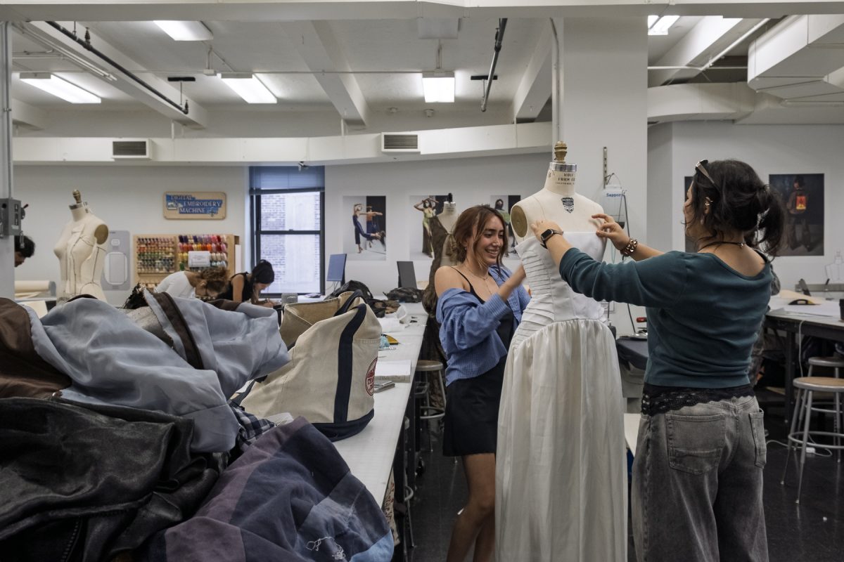 Sofia Vazquez, a junior fashion design major, and Yasmine Karkouch, a senior fashion design major, set up Vazquez's dress on a dress form for her Patternmaking and Construction III class in the fashion lab on the seventh floor of 623 S. Wabash Ave. on Tuesday, Oct. 13, 2026.
