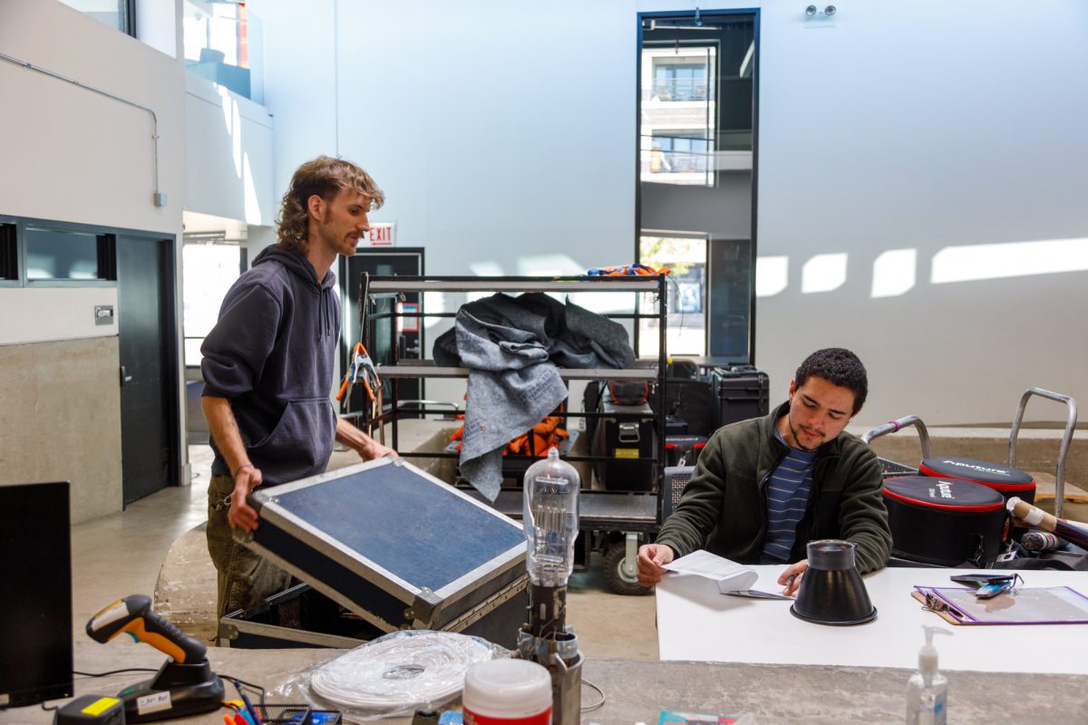 Senior film and television majors Ian Finley and Jose Santiago assist with equipment checkout in the Media Production Center on the first floor of the 1600 S. State St. building on Monday, Oct. 19, 2026.